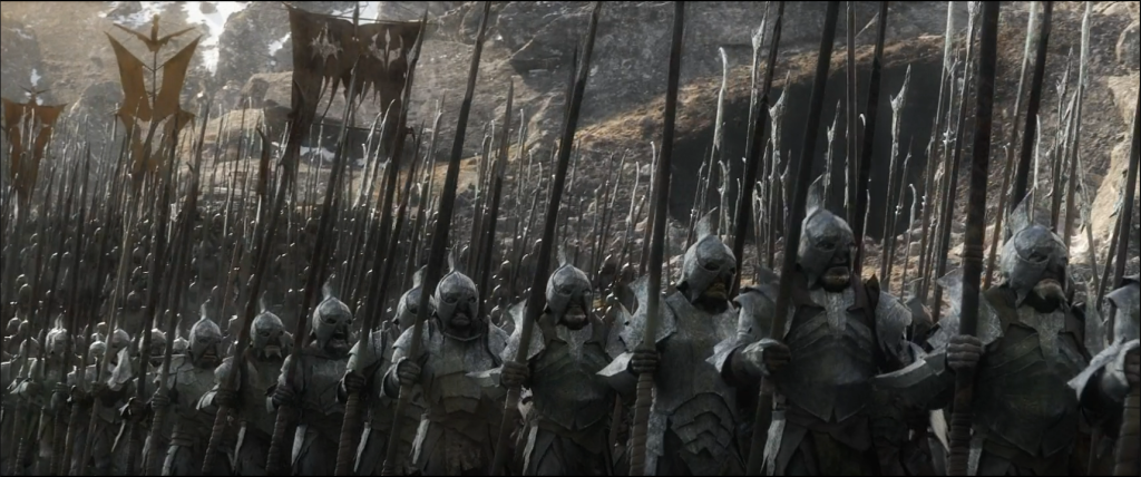 An image of an orc army from The Hobbit: The Battle of Five Armies. They're lined up in menacing ranks, in nigh-identical armour. The perfect goons to be destroyed.